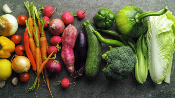 istock Large selection of fresh multicolored healthy vegetables on a rustic, mottled grey background. 2077444899