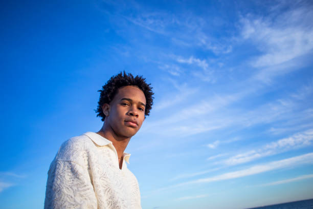 istock Portrait of young man on the beach 2077458452