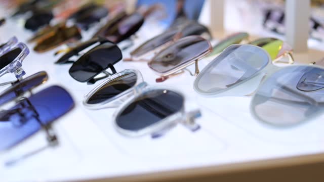 Closeup stylish models of sunglasses on display accessories Glasses of graceful shapes and bright colors, meeting latest fashion trends in accessories Accessories will be highlight of fashionable look