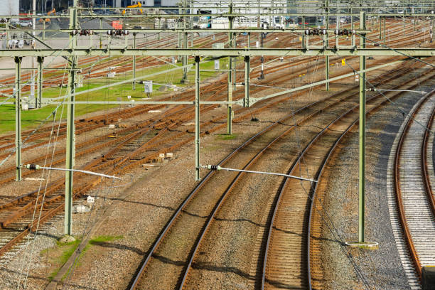 istock Brown rusted railroad tracks and overhead lines 2077477308