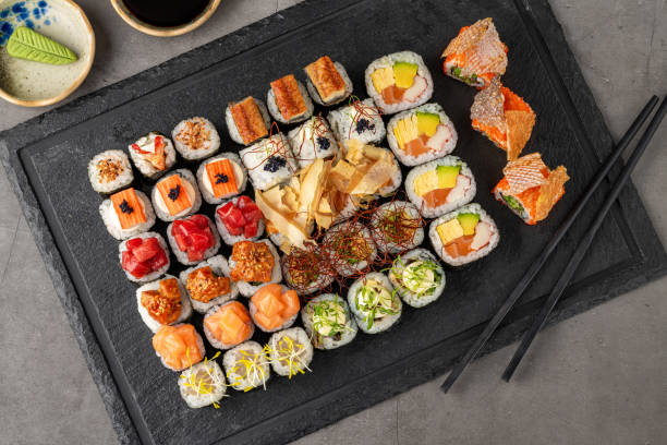 istock Sushi set of various products on a black stone plate 2077477835