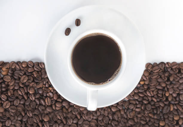 Details of coffee beans and cups taken in a photographic studio