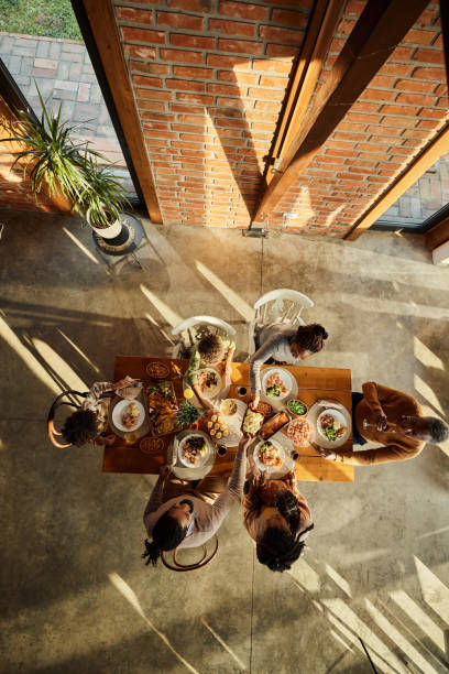 istock Above view of black extended family having lunch at dining table. 2077493020