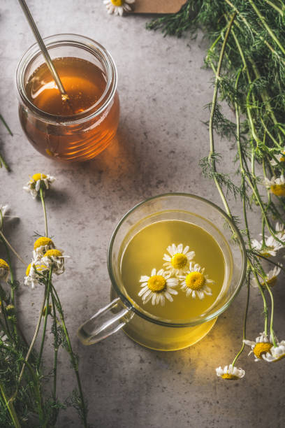 istock Herbal tea with organic herbs and honey on dark concrete background. 2077503753