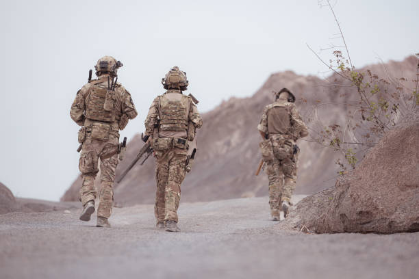 istock Soldiers in camouflage military uniforms carrying weapons, Reconnaissance missions in rugged mountains, Assault infantry battle training. 2077511708