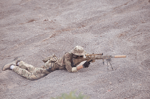 Soldiers in camouflage military uniforms carrying weapons, Reconnaissance missions in rugged mountains, Assault infantry battle training.