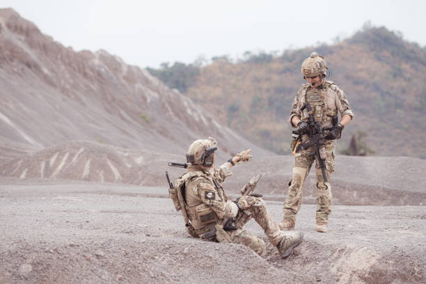 istock Soldiers in camouflage military uniforms carrying weapons 2077538168