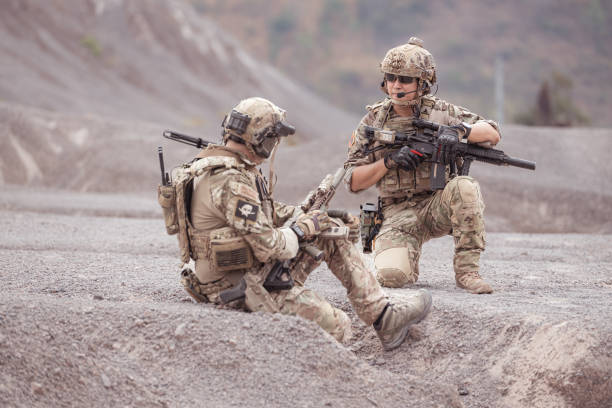 istock Soldiers in camouflage military uniforms carrying weapons 2077538681
