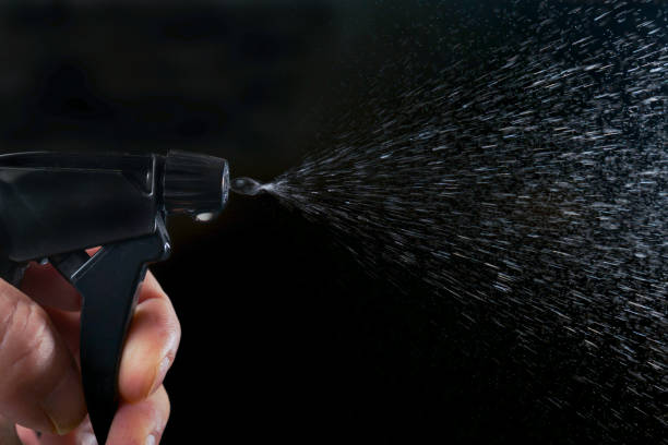 istock a man's hand pressing the trigger of a sprayer, 2077539223