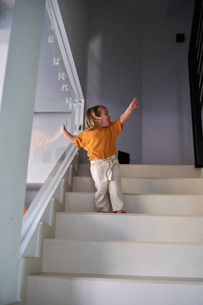 istock Little girl asking for help for going downstairs. 2077560625