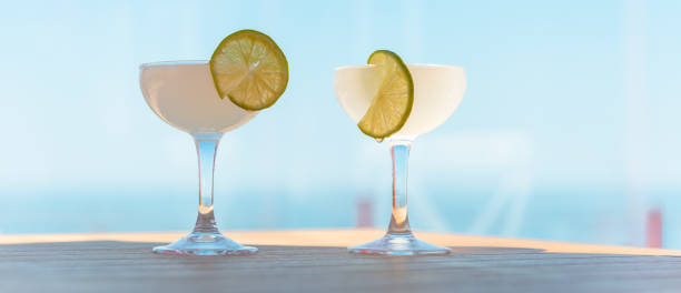 banner,advertisement.two drinking glasses of margarita cocktails. beach bar concept. summer alcoholic cocktails on table bar, sea on background. - 13607 fotografías e imágenes de stock