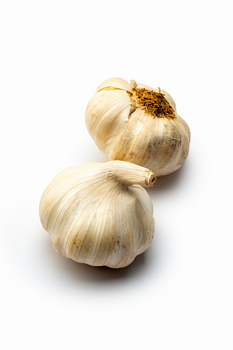 Two heads of garlic , isolated on white background.	Studio shot.