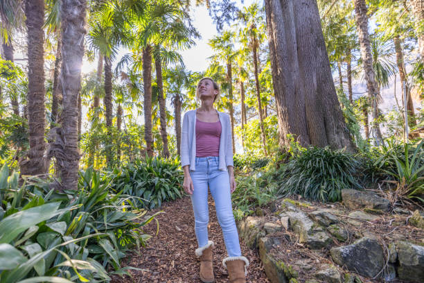istock Woman taking a walk in a lush green forest 2077591263