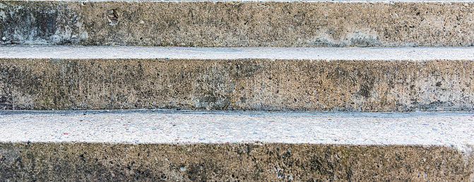 Old stairs.Old aged beige,gray stairs textured background.Closeup.