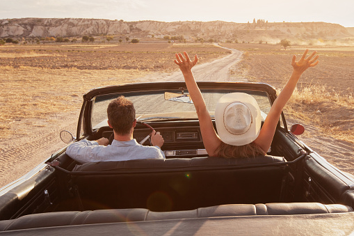happy couple in cabriolet car, people in vintage rental car, summer travel