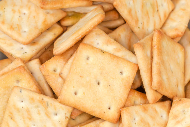 Studio shot of mini cheddar cheese biscuits cut out against a white background.