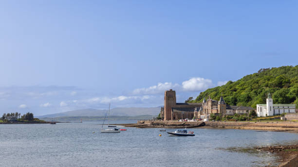 istock Oban Bay glistens under the soft light, framing St Columba's Cathedral, with yachts floating gently on the water 2077627106