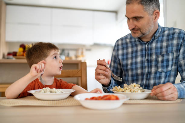 istock Dad and son having lunch at home 2077629816