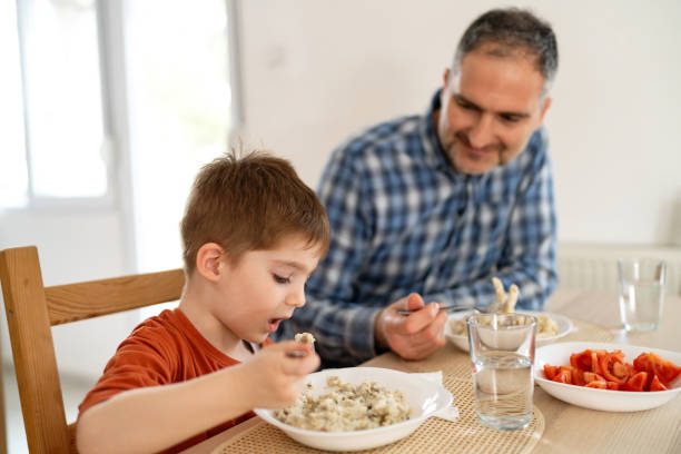 istock Dad and son having lunch at home 2077631546