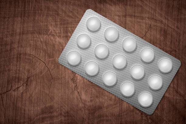 Pills in package on wooden desktop. 3d illusration.