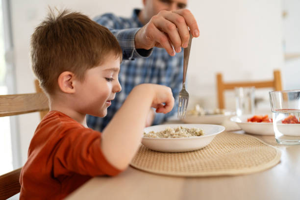 Dad and son having lunch at home.