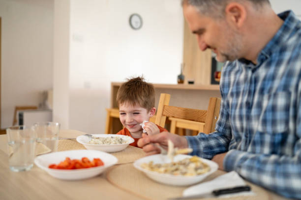 istock Dad and son having lunch at home 2077633552