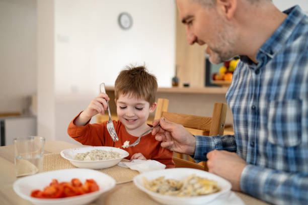 istock Dad and son having lunch at home 2077634260