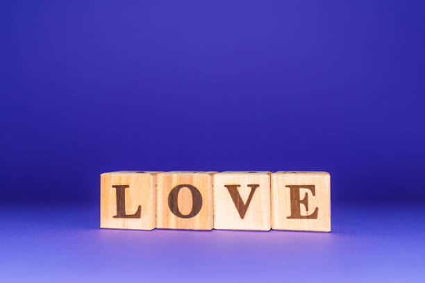 istock love text on wooden blocks. purple, veri peri background.copy space. 2077636303