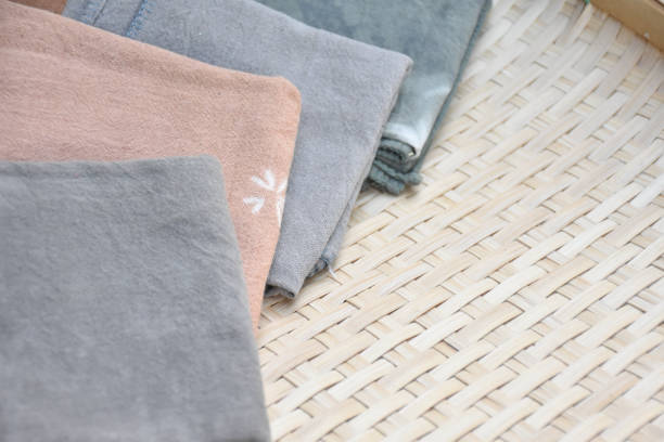 Tie dye cotton clothes; handkerchief on wooden background for selling and using in daily life.