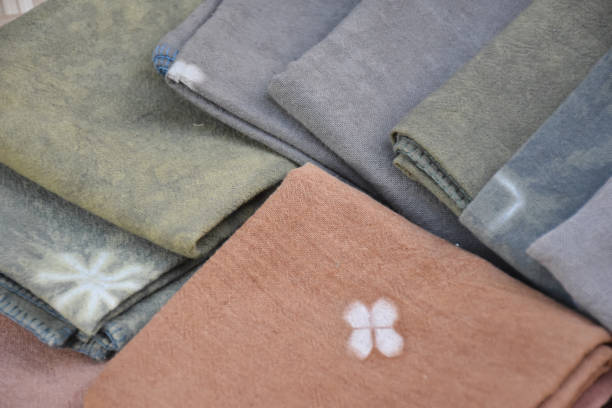 Tie dye cotton clothes; handkerchief on wooden background for selling and using in daily life.
