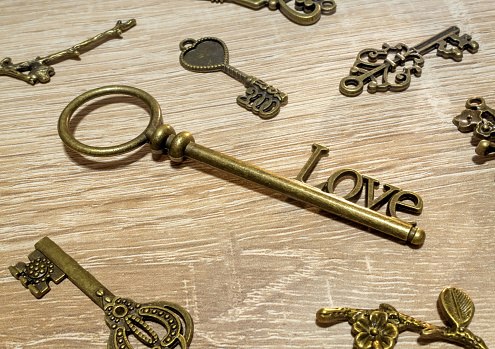 Vintage love keys on the wooden background. Unique romantic concept.