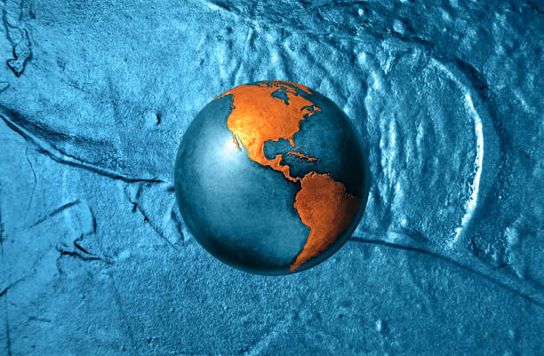 Metalic earth globe on the blue metal texture. Industrial environmental consciousness metaphor.