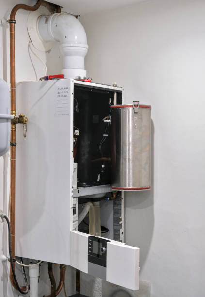istock Maintenance of the heating element of a gas-fired central heating boiler. 2077686059