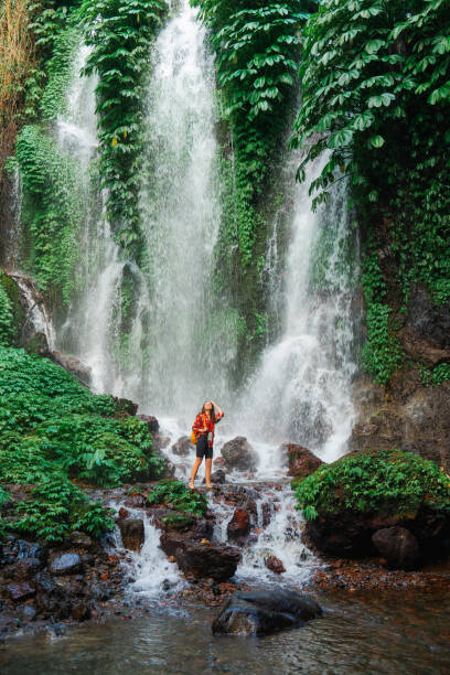 istock Woman exploring near the refreshing waterfall on Bali 2077692927