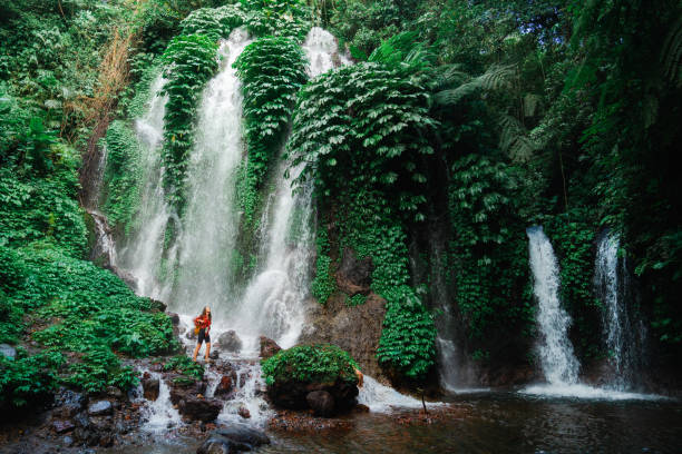 istock Woman exploring near the refreshing waterfall on Bali 2077692930