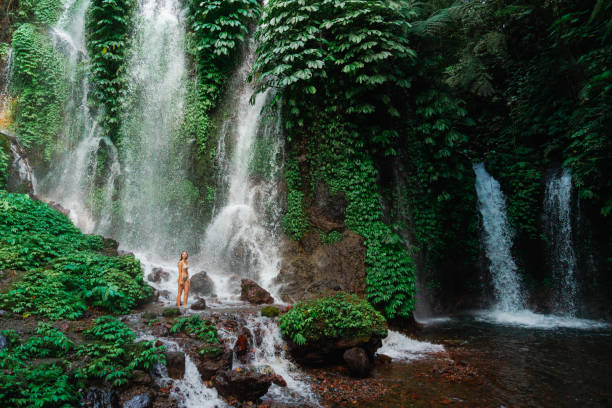 istock Woman swimming in the waterfall on Bali 2077693479