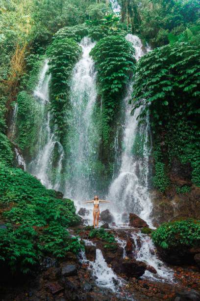 istock Woman swimming in the waterfall on Bali 2077693490