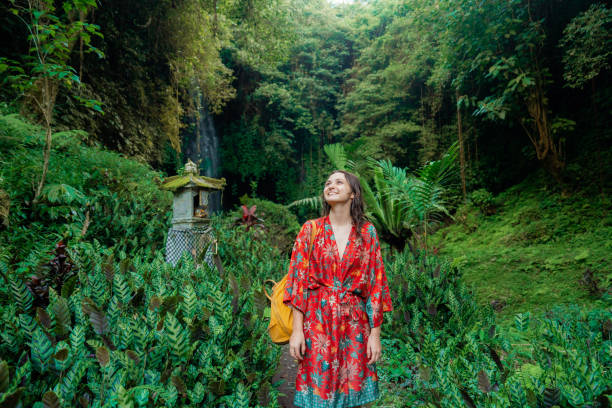 istock Woman walking in tropical garden 2077697670