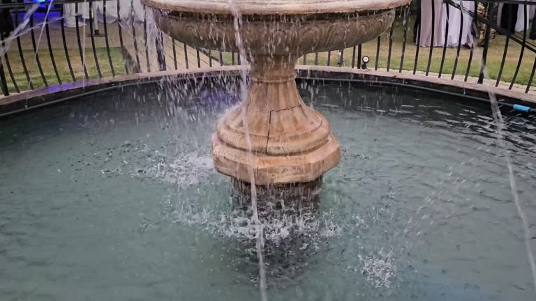 Small fountain made of natural stone in a city park