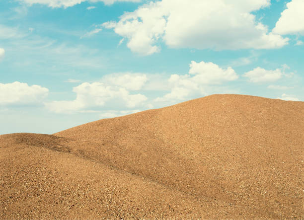 The river gravel pile is sold for cement use in construction.