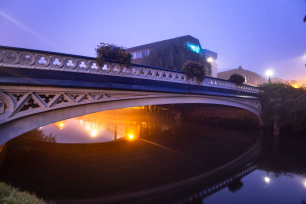 Early morning fog city lights reflections River Wey bridge Guildford Surrey England Europe