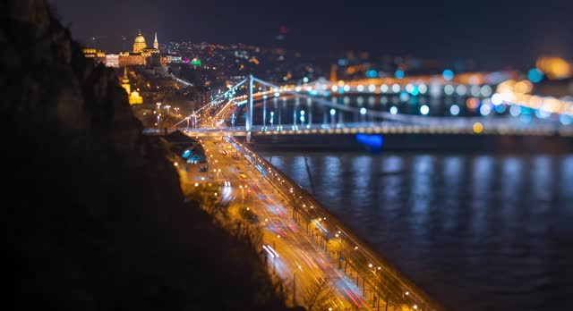 Cityscape view. Buda castle and Erzsebet Bridge on the background. Focus tilted to the castle and main road. Time-lapse, move transition.
