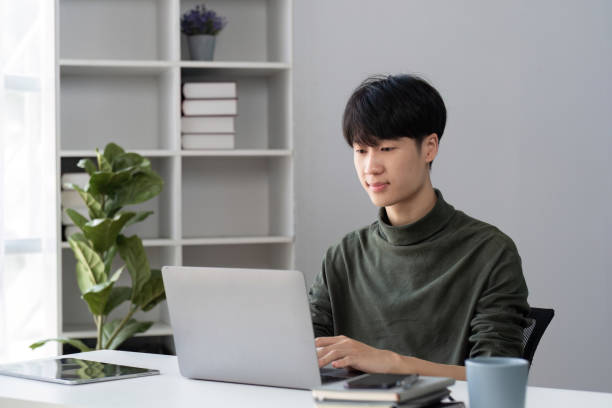 istock Portrait of a handsome young office worker intently studying how to do a presentation project on a laptop in his office. 2077718228