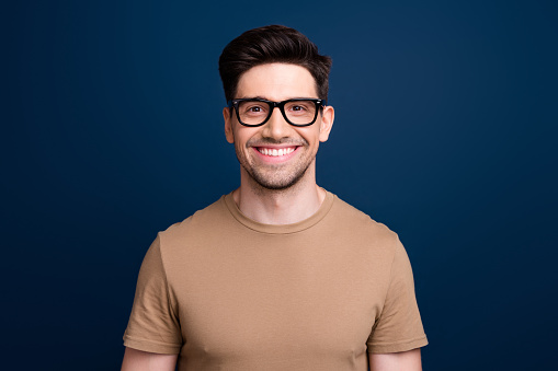 Photo of funky positive man wear trendy clothes spectacles sale discount optics shop isolated on dark blue color background.
