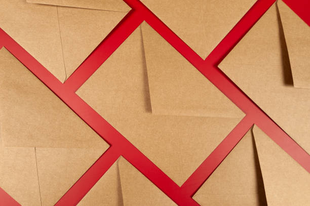 istock Top view of kraft envelopes on red background. 2077732436