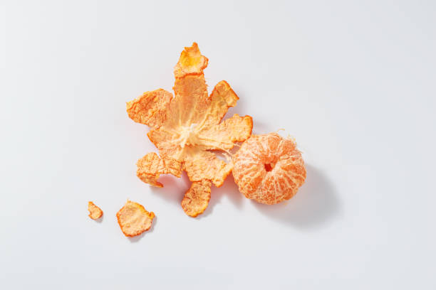 istock Peeled tangerine with peel on white background 2077738904