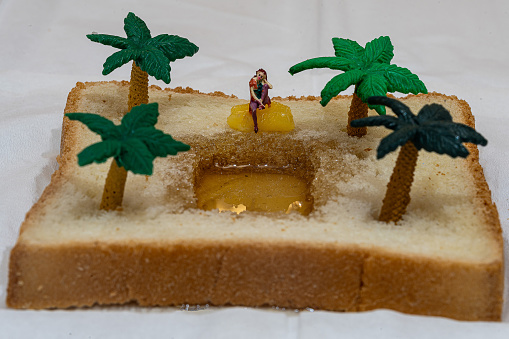 A slice of bread with honey and miniature palm trees on top