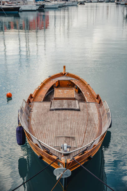 Closeup shot of a modern wooden sailing boat docked at the harbour. A luxury wooden sailing boat parked at the harbour bilge of ship stock pictures, royalty-free photos & images