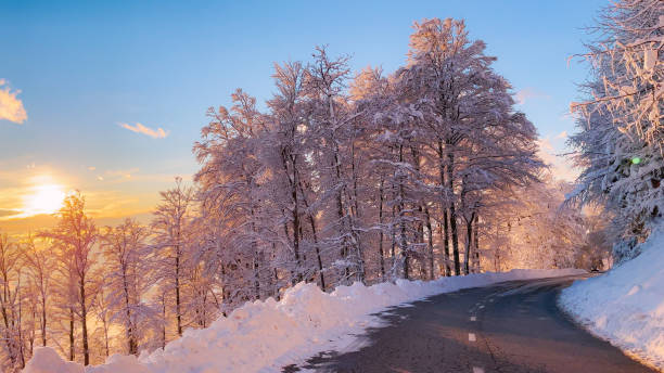 istock Beautiful day for drive through hilly landscape covered with freshly fallen snow 2077786392