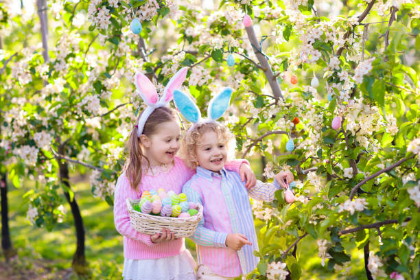 istock Easter egg hunt. Kids with bunny ears and basket. 2077807275